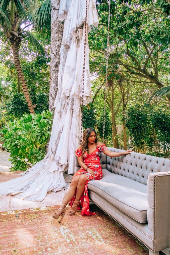 An influencer interview with Lifestyle Instagram influencer Naomi Genota or @naohms on Instagram who is sitting on a swing in Tulum here
